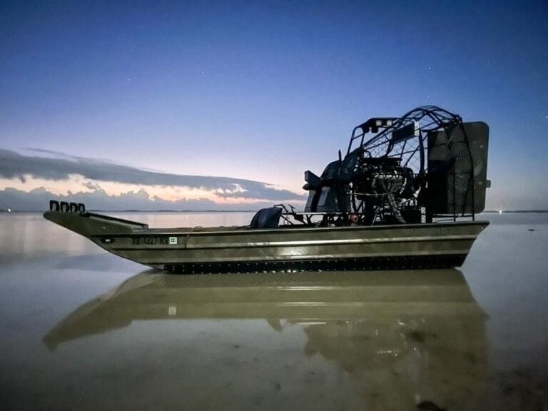 Patriot airboat sitting on calm water at dusk