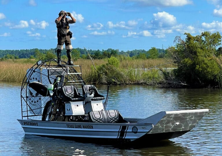 A Texas game warden standing watch from his Patriot