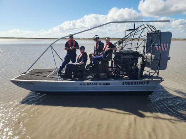 U.S. Coast Guard crew aboard a Patriot airboat beached on a sandbar