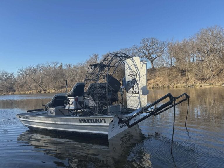 A Patriot with deck rails tied up on a Texas river
