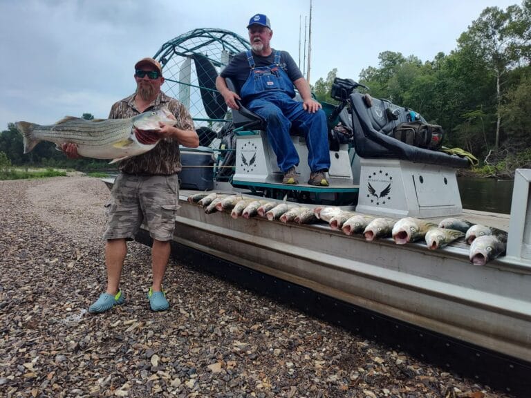 An angler with a big gar beside his Patriot