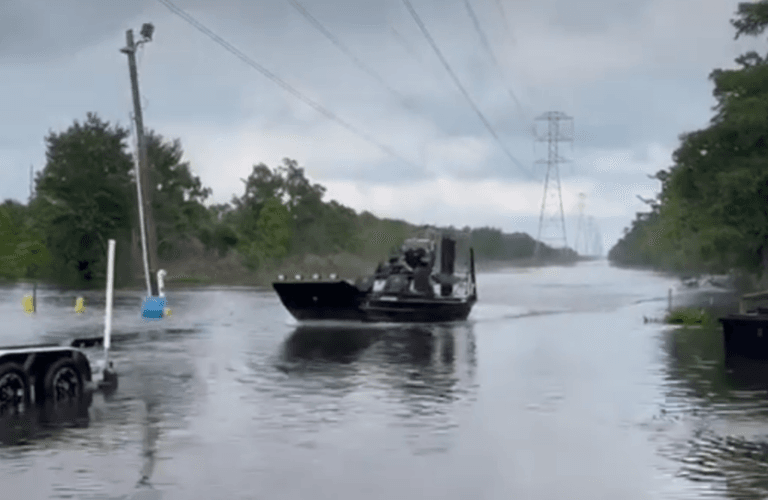 An airboat running a flooded road