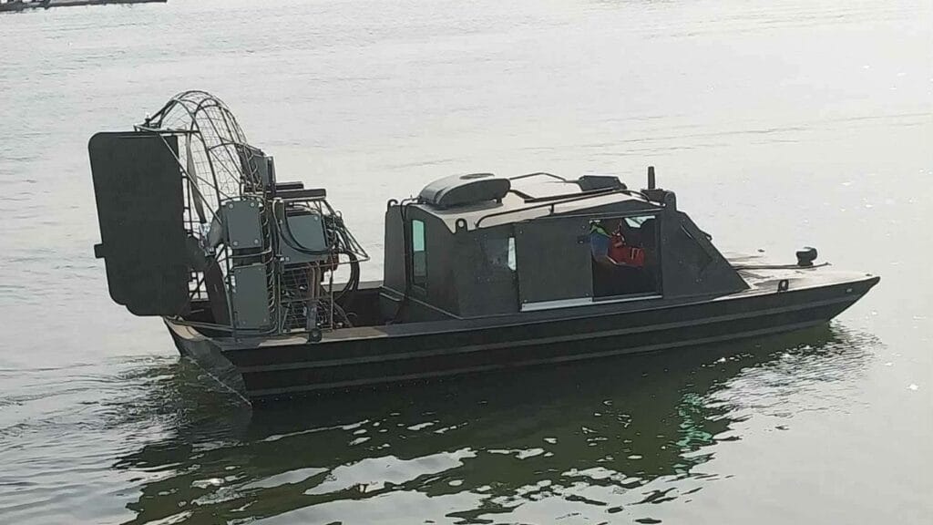 A military cabin airboat on open water