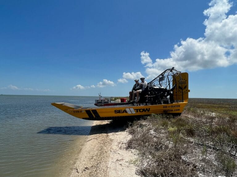 A Sea Tow Patriot beached on a sandy point