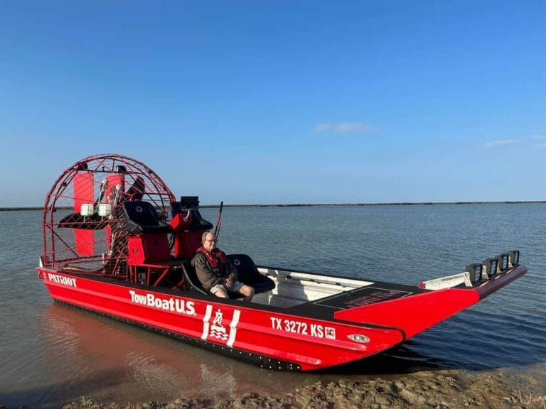 A red towing airboat on the beach