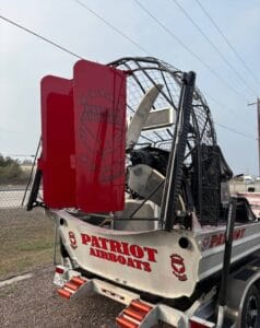 2025 Patriot airboat rear quarter view with red rudders and transom lettering