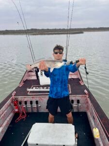 Man posing with fish on 2025 Patriot airboat