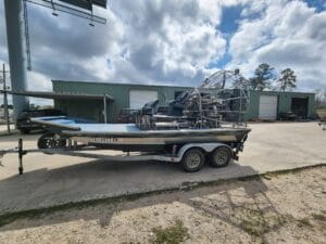 2019 Diamondback 18x8 airboat with a blue deck on a tandem trailer, side view