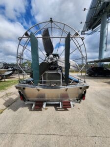 2019 Diamondback airboat from the stern, stainless cage and green rudders