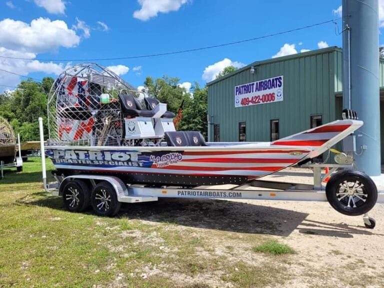 A flag-wrapped Patriot on its trailer at the shop