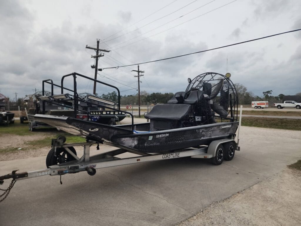 2008 Diamondback 18x8 airboat in black and gray wrap on a Coastline tandem trailer