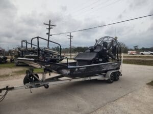 2008 Diamondback 18x8 airboat in black and gray wrap on a Coastline tandem trailer
