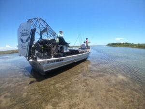 Anglers fishing from a 2023 Patriot airboat in clear shallow water