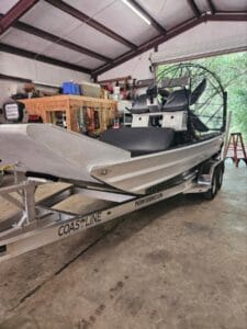 2023 Patriot airboat on its Coastline trailer in the shop, front view