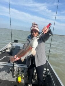 Angler holding a redfish aboard a 2023 Patriot airboat