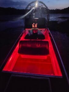 Red LED deck lighting on a 2023 Patriot airboat at night