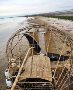 Driver's seat, control stick and cage of a 2018 AirRanger airboat on a sand flat