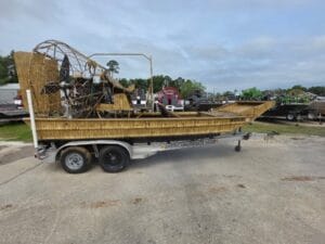 2018 AirRanger 18x8 airboat in grass camo wrap on a tandem trailer, side view