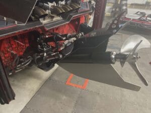 Surface drive propeller and exhaust under the transom of a 2019 Swamp Shark mud boat