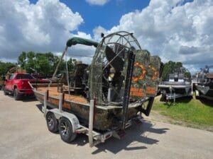 2017 Diamondback 17x8 airboat in camo wrap with a bimini top on a tandem trailer