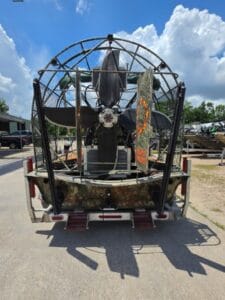 2017 Diamondback airboat from the stern, prop, cage and camo-wrapped transom