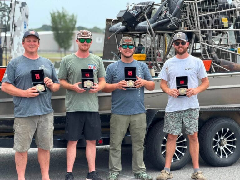 The winning bowfishing team in front of their airboat