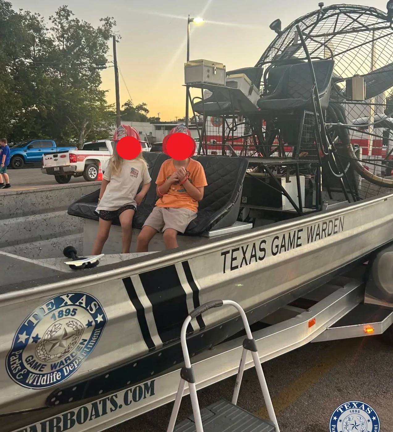 Visitors on the deck of a Texas Game Warden Patriot airboat, with the Patriot Airboats hull wrap and the Parks and Wildlife seal