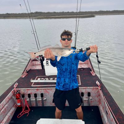 Man posing with fish on 2025 Patriot airboat